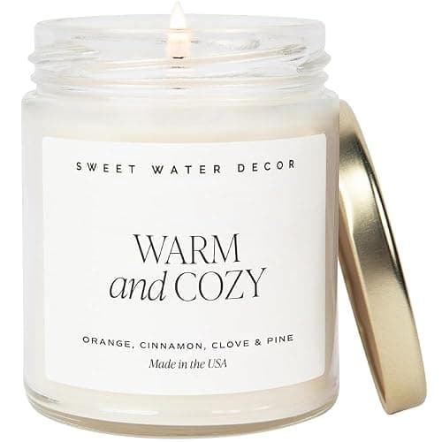 Sweet Water Decor Warm and Cozy Candle - Orange Peel, Cinnamon, Ginger and Clove Soy Winter Scented Candles for Home - 9oz Clear Jar + Gold Lid, 40+ Hour Burn Time, Made in the USA - Warm and Cozy - Text Label - Image 1