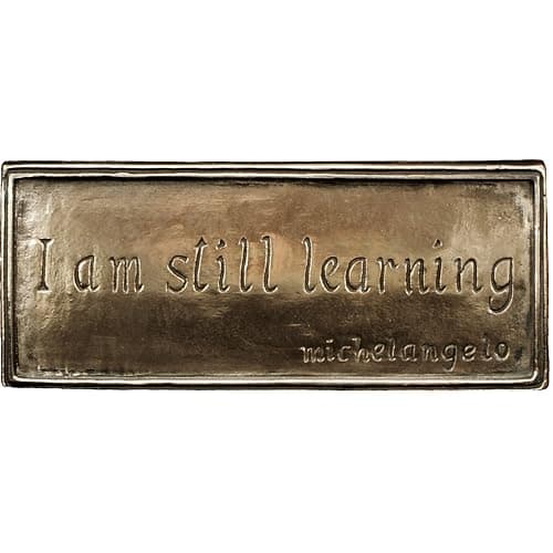 Wild Goose Studio I Am Still Learning Irish Plaque Michelangelo Quote Resin Cast Coated In Bronze Indoor Outdoor 2 1/2 Inches Tall By 6 Wide Made in Ireland - Image 1