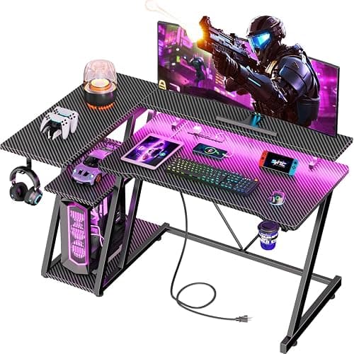 Korfile 40 Inch Gaming Desk with Power Outlet & LED Lights, L Shaped Computer Gaming Table with 3 Tiers Storage Shelves, Corner Gamer Desk with Monitor Stand for Small Space, Carbon Fiber Black - Image 1