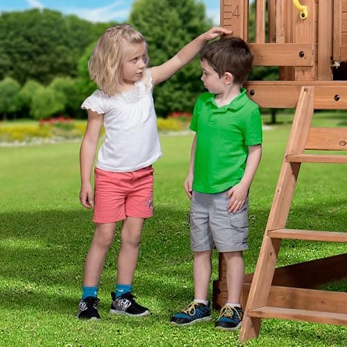 Backyard Discovery Scenic Heights Elevated Cedar Wooden Kids Playhouse with Play Kitchen, Wrap-Around Deck, Toy Storage Bench, Saloon-Style Doors, Ladder, Stairs, and Growth Chart for Outdoor Play thumbnail 7
