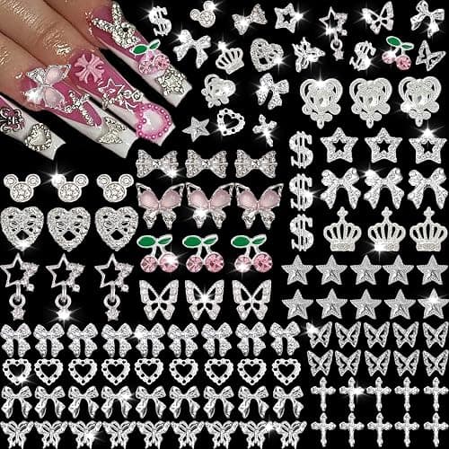 KACHIMOO 106 Pcs Nail Charms and Gems Silver Nail Charms Nail Rhinestones for Nails Design 3D Butterfly, Bow, Star,Cherry,Cross,Dollar,Heart Shapes for Acrylic Nails (19 Styles) - Image 1