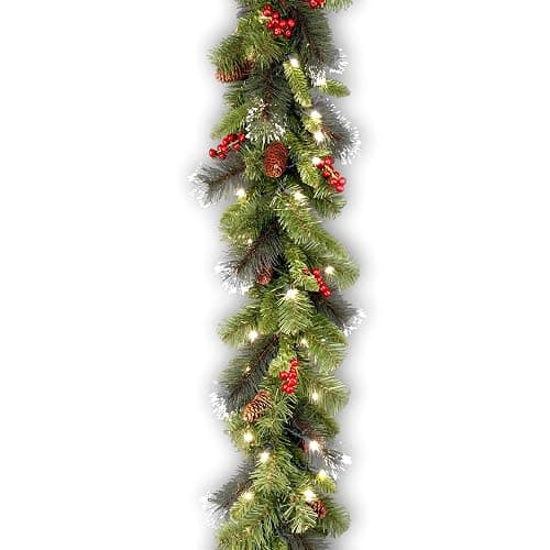 National Tree Company 9 ft Pre-Lit Crestwood Spruce Artificial Christmas Garland, Christmas Decoration with Glitter, Pinecones, Red Berries, 50 Clear Lights, 180 Tips, Green - Image 1