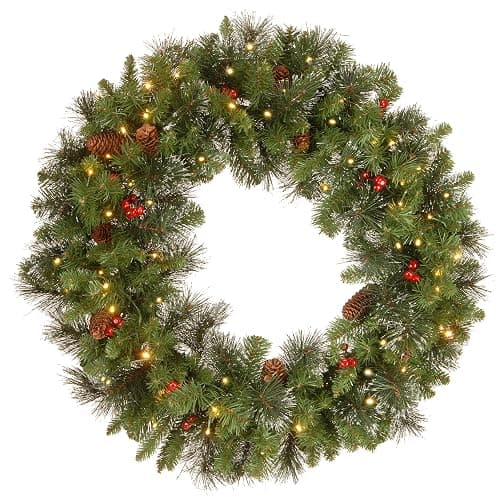 National Tree Company Pre-Lit Artificial Christmas Wreath, Green, Carolina Pine, White Lights, Decorated with Pine Cones and Glitter, Berry Clusters, Christmas Collection, 30 Inches | 70 Clear Lights, 200 Tips, Artificial Christmas Decoration With Glitter, Pinecones, Red Berries, Green - Image 1