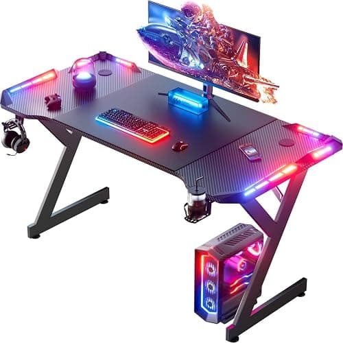 HLDIRECT 47 Inch Gaming Desk with LED Lights, Ergonomic Computer Gaming Table with Carbon Fibre Surface, Sturdy PC Workstation Desk for Home Office with Headphone Hook, Cup Holder, Black - Image 1