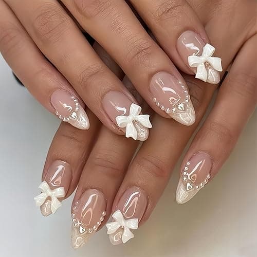 24Pcs White French Tip Almond Medium Fake Nails with Cute Bow Charms Design Nude Pink Acrylic Nails White Pearls Bow Full Cover Glue on Nails Glossy Stick on Nails Heart Artificial Nails for Women - Image 1